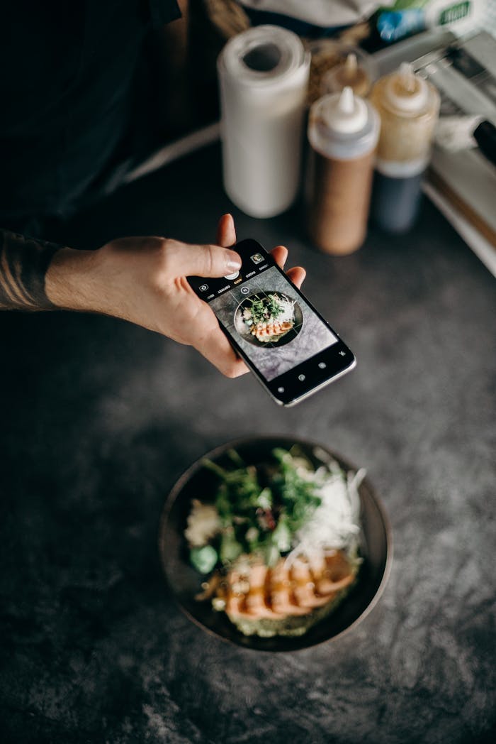 Person Taking Photo of Dish in Bowl